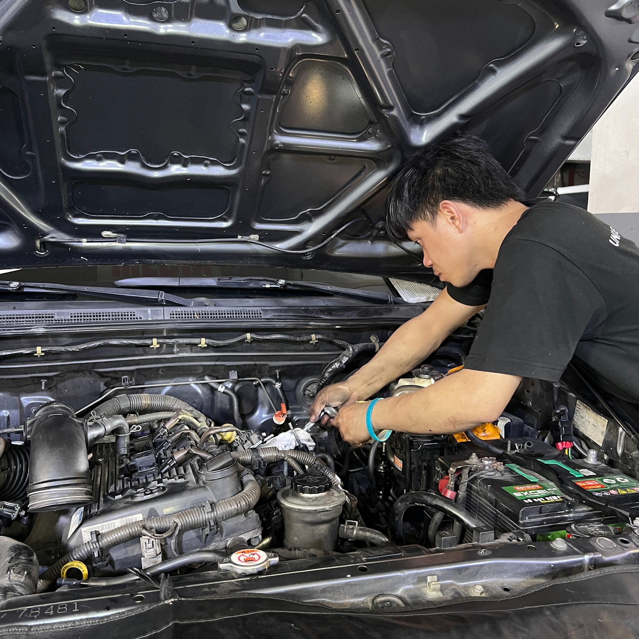 Underchargers mechanic working on a vehicle