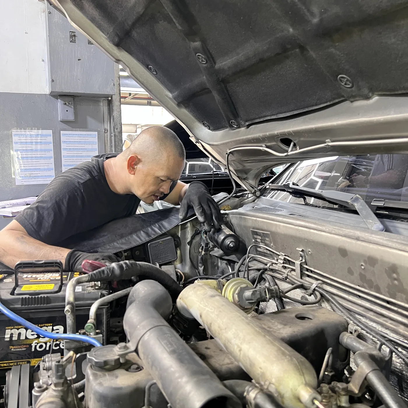 Underchargers mechanic servicing an engine bay